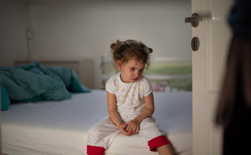 Little girl crying in bedroom