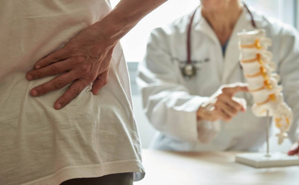 A doctor explaining lumbar anatomy to back pain patient