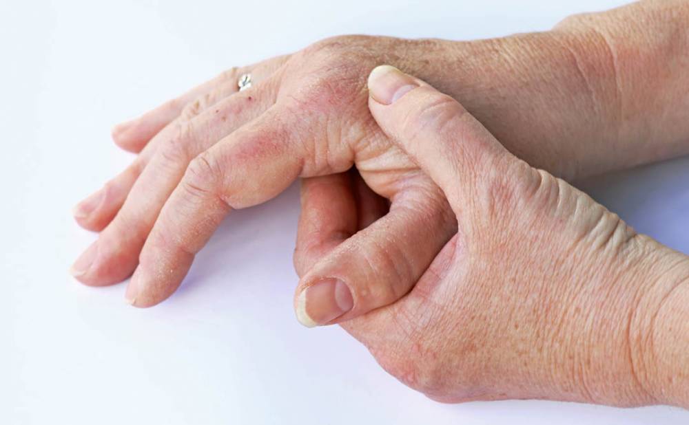 An elderly woman has pain in her hands